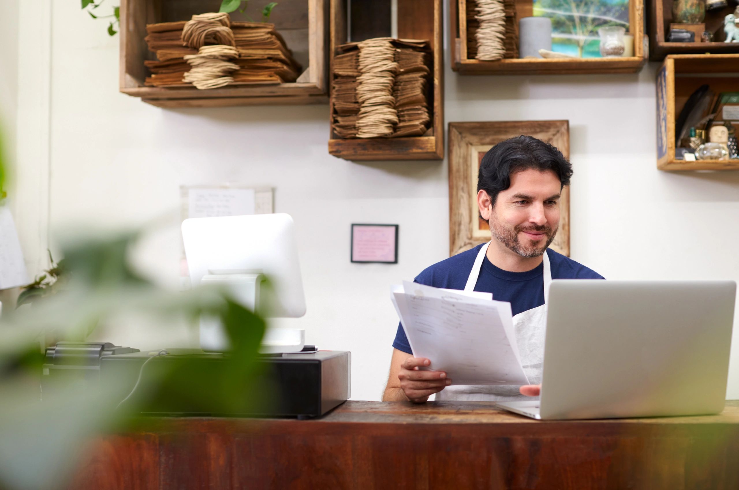 Small business owner working behind a shop desk