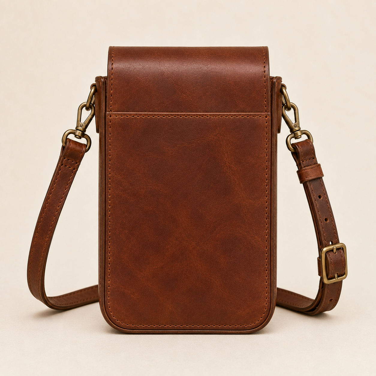 Back - Old Line Crafts & Designs Rear studio view of the brown leather Marketline Crossbody Bag showing the clean back panel flap construction side D rings and adjustable strap