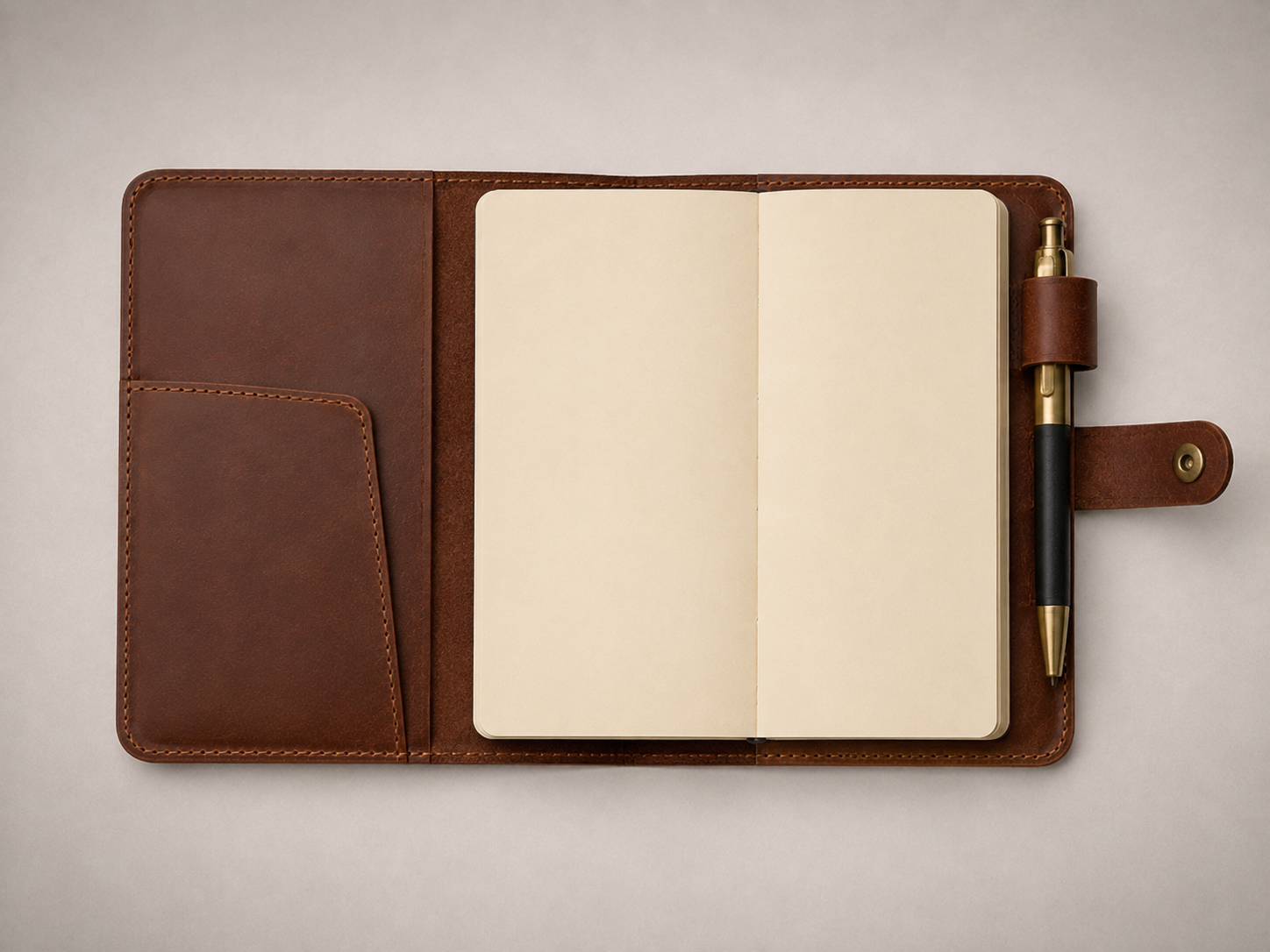Open - Old Line Crafts & Designs An open brown leather journal cover showing the A5 notebook retained inside with an interior diagonal pocket and a pen loop beside the notebook